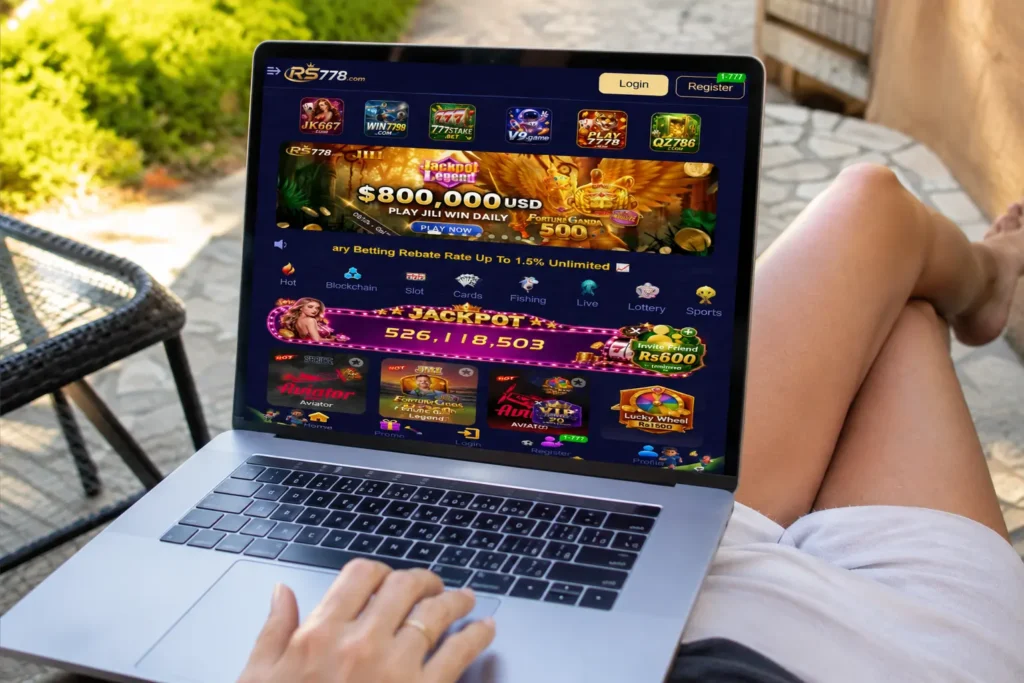 Woman using laptop outdoors on RS778 Game apk platform showing JILI slots, Aviator, live jackpot and real money games in Pakistan